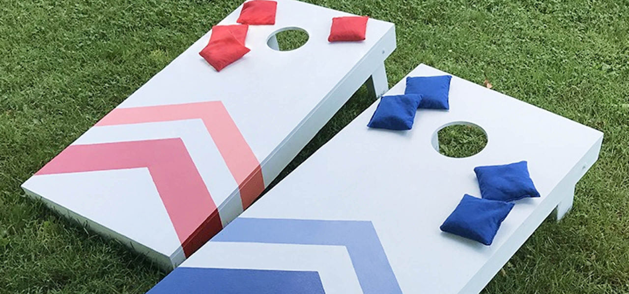 Cornhole game set with geometric designs on a grassy background